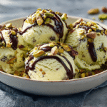 pistachio ice cream scoops served with toppings