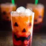 A selection of colorful Halloween drinks in spooky-themed glasses.
