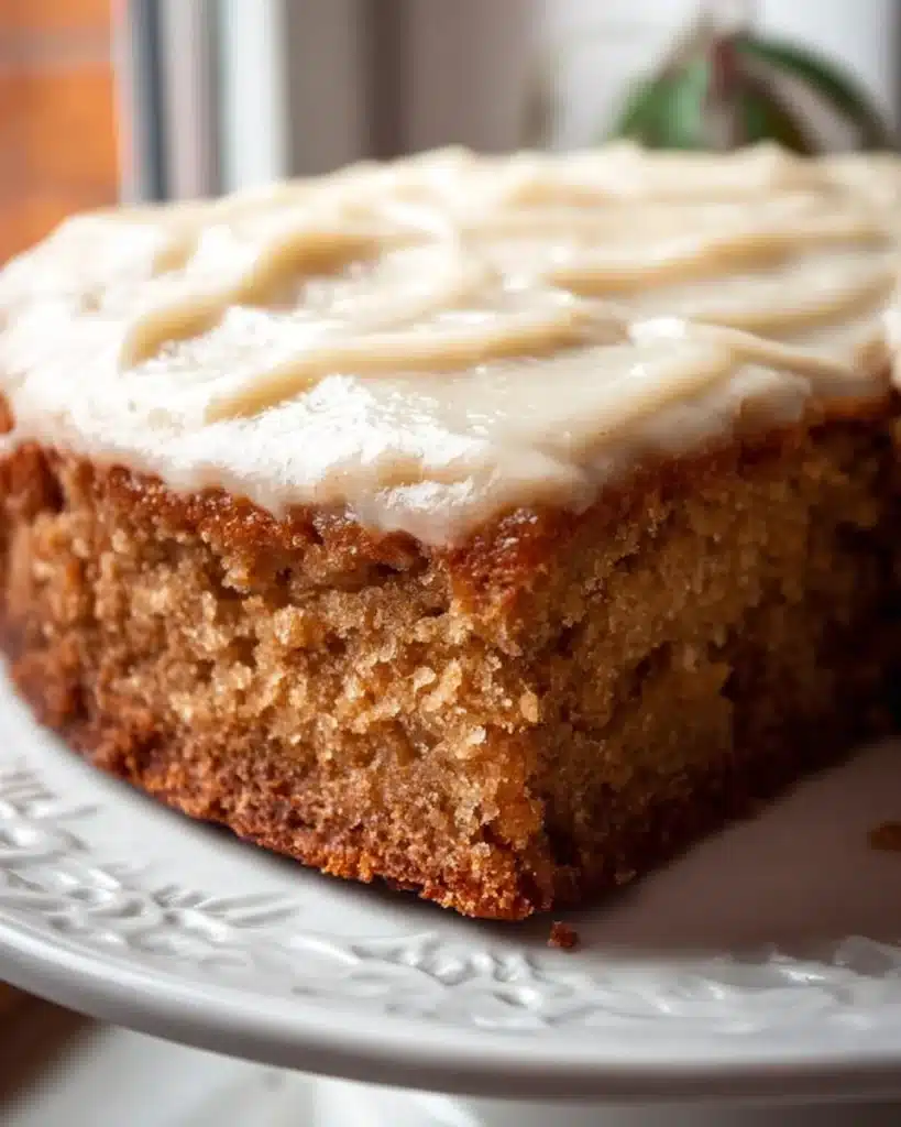 Delicious slice of healthy applesauce cake topped with frosting