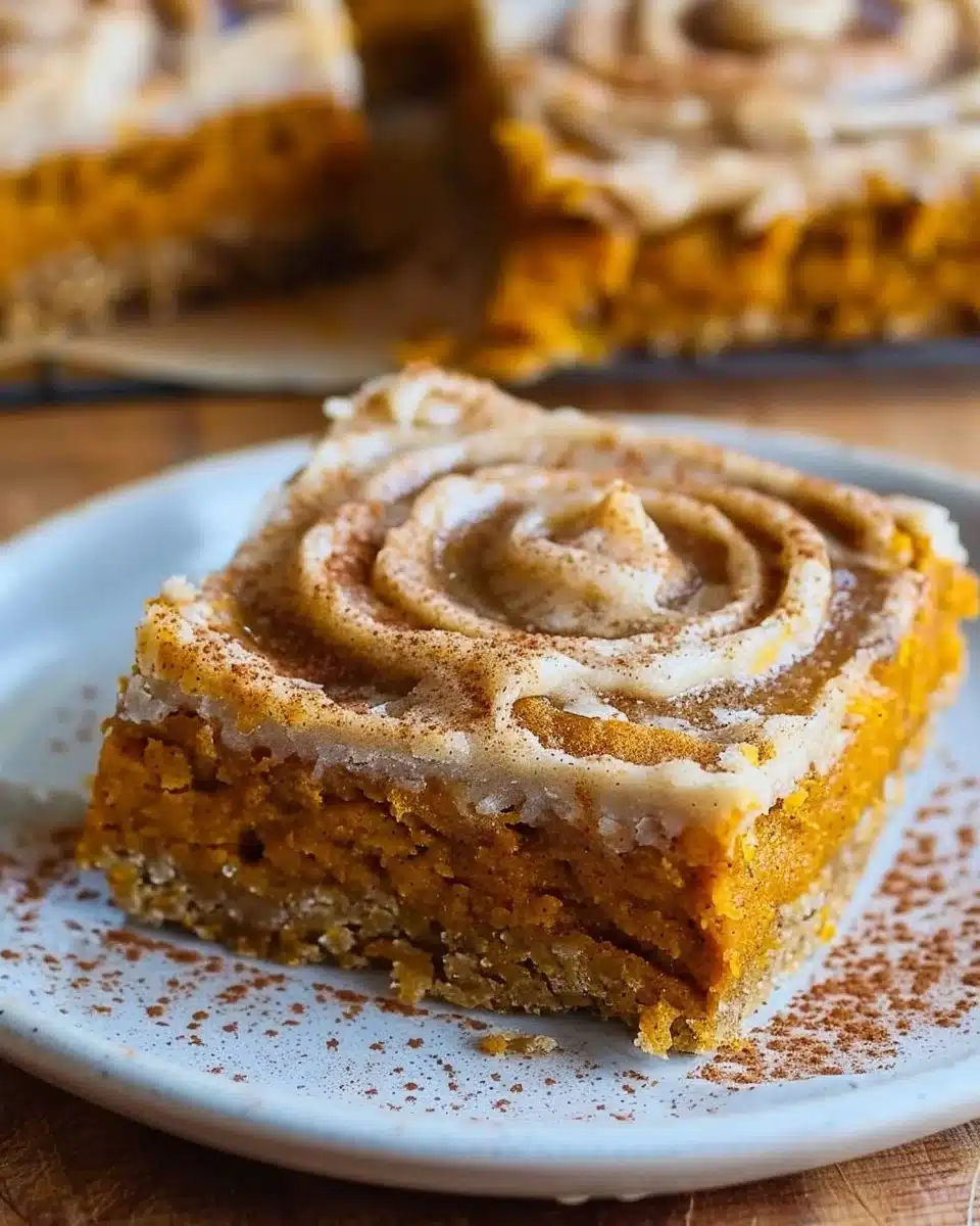 Delicious pumpkin bars with creamy frosting on top, perfect for fall desserts.