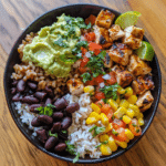 Healthy Chicken Taco Bowl with Roasted Vegetables and Avocado Lime Crema